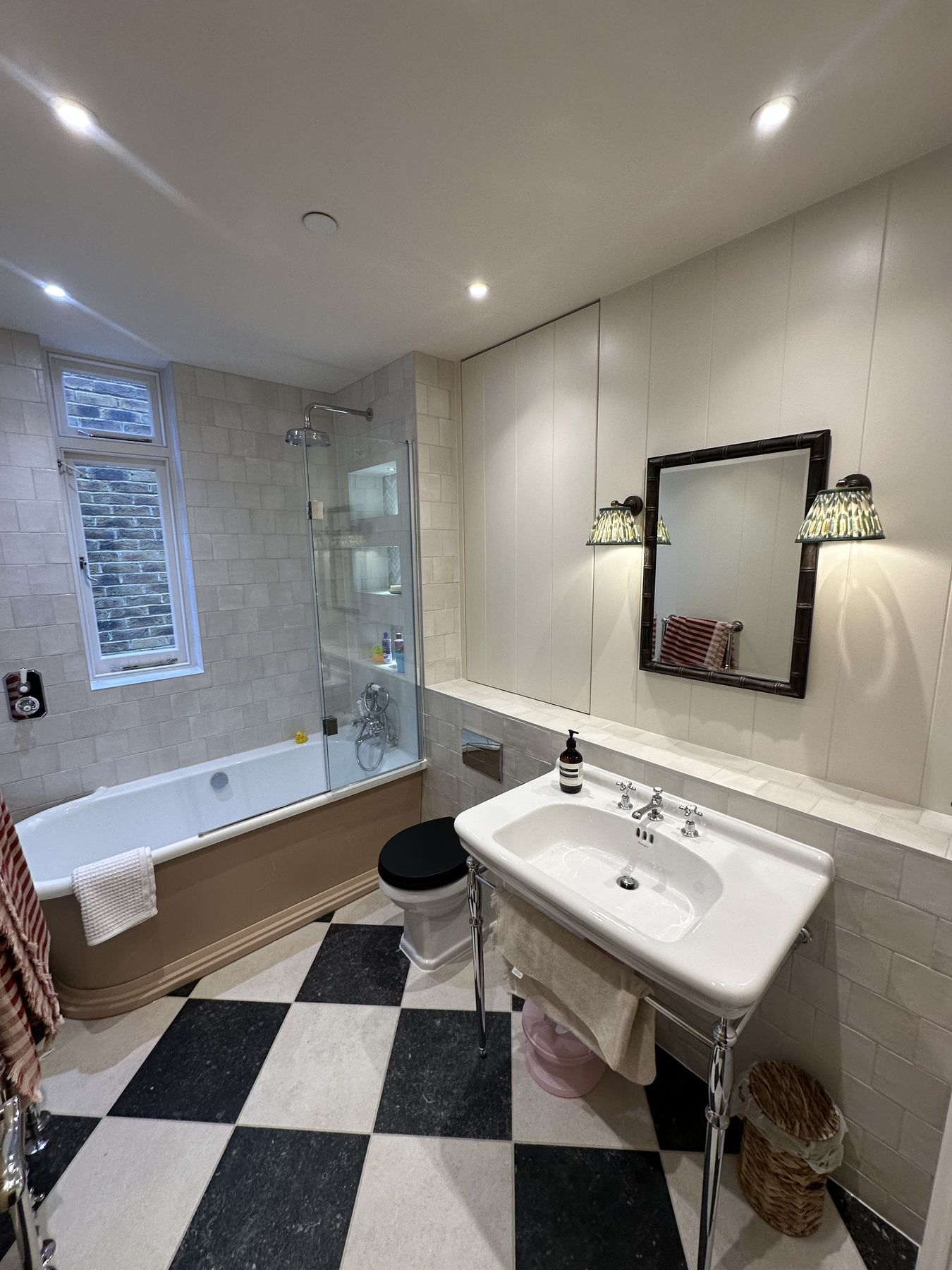 Chrome washstand with a period mirror and wall lights