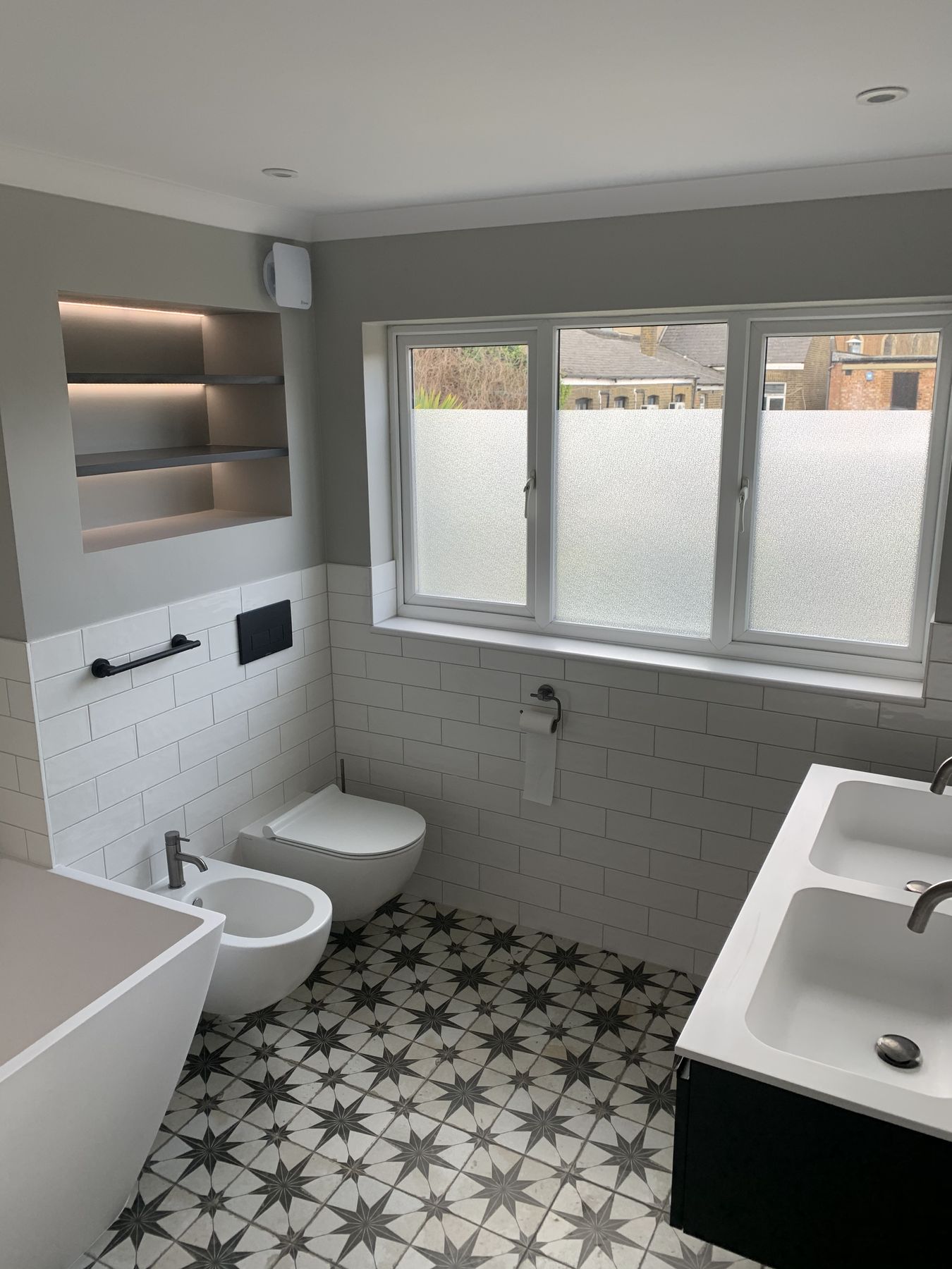 Metro-tiled walls and lit recessed shelving